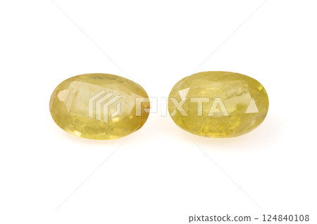 Natural Golden Yellow Faceted Oval Sphene Gemstones on White Background 124840108