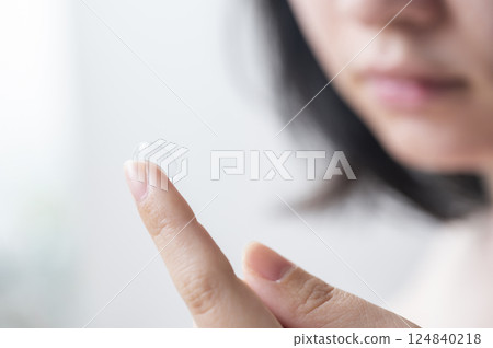 A woman wearing a contact lens A woman wearing a contact lens 124840218