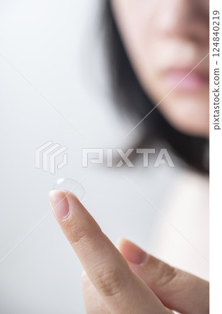 A woman wearing a contact lens A woman wearing a contact lens 124840219