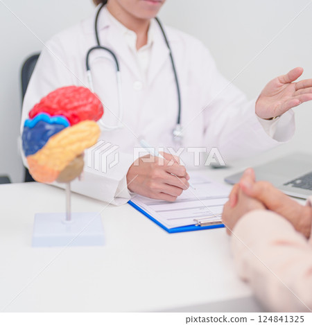 Elderly Patient consulting Doctor to Brain disease, Senior Health Medical Diagnosis. Anatomy Brain model for Explanation, Brain Tumor, neurological disorders, Dementia, alzheimer, parkinson and Mental 124841325