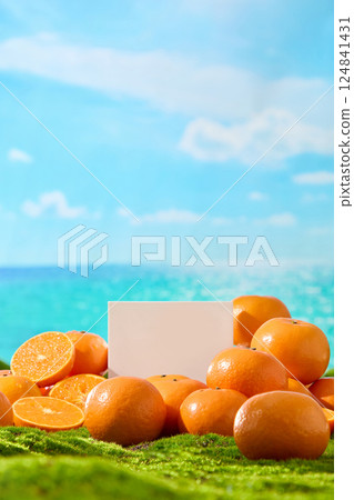 A tall square platform surrounded by ripe oranges, with space above for advertising products. Shown on a green lawn and a blue sky with white clouds. Vertical shot with outdoor scenery. A tall square platform surrounded by ripe oranges, with space above for advertising products. Shown on a green lawn and a blue sky with white clouds. Vertical shot with outdoor scenery. 124841431