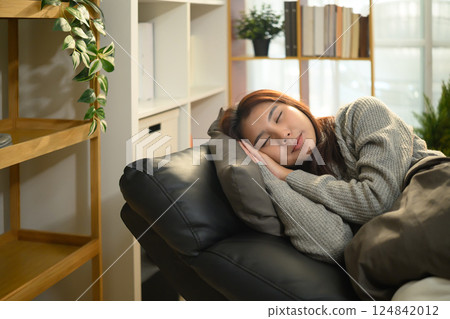 Young asian woman is sleeping on comfortable armchair with a pillow 124842012