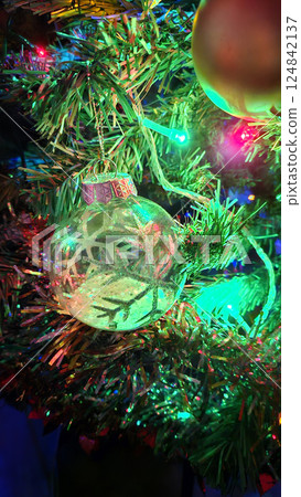 Christmas tree decorated with beautiful transparent ball with abstract snowflake 124842137