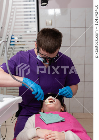 Modern dental care experience at a clinic, showcasing patient receiving oral treatment while dentist focuses on precision and comfort during procedure Modern dental care experience at a clinic, showcasing patient receiving oral treatment while dentist focuses on precision and comfort during procedure 124842410