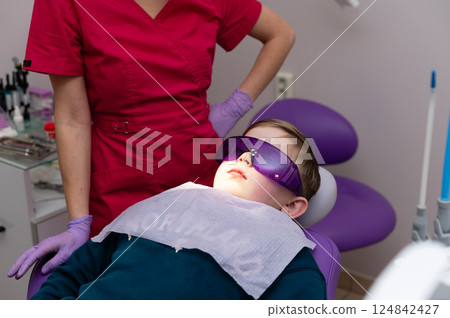 Bright smiles and gentle care take center stage as a young patient prepares for a dental checkup in a modern clinic setting 124842427