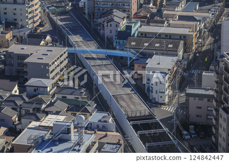 Red Train Passing by Canal in Urban City Neighborhood Dec 8 2024 Red Train Passing by Canal in Urban City Neighborhood Dec 8 2024 124842447