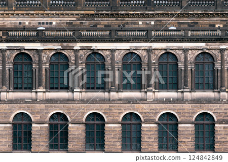 Building facade with arched windows. 124842849