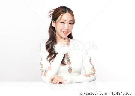 A beautiful young Asian woman with clean, fresh skin against a white background. Skincare, facial treatment, cosmetology, beauty, and spa. An elegant portrait of an Asian woman. 124843163