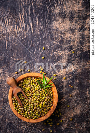 Raw uncooked mung beans on black background Raw uncooked mung beans on black background 124843202