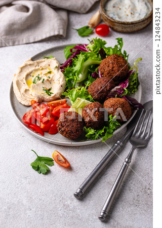 Salad with hummus, falafel and vegetables 124843234