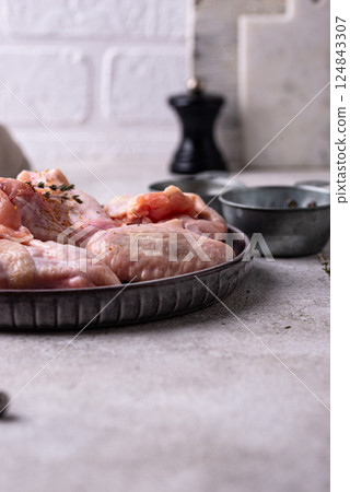 Raw chicken wings on black background. 124843307