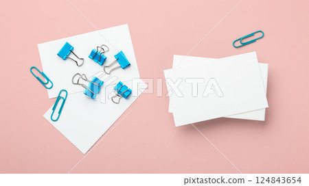 Business card mockup with blue binder clips on pink background Business card mockup with blue binder clips on pink background 124843654