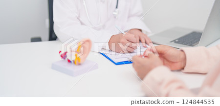 Elderly Patient consulting Doctor to Ear disease. Senior Health Medical Diagnosis. Anatomy Ear model for Atresia, Otitis Media, Pertorated Eardrum, Meniere syndrome, otolaryngologist, Hearing Loss 124844535