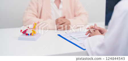 Elderly Patient consulting Doctor to Ear disease. Senior Health Medical Diagnosis. Anatomy Ear model for Atresia, Otitis Media, Pertorated Eardrum, Meniere syndrome, otolaryngologist, Hearing Loss Elderly Patient consulting Doctor to Ear disease. Senior Health Medical Diagnosis. Anatomy Ear model for Atresia, Otitis Media, Pertorated Eardrum, Meniere syndrome, otolaryngologist, Hearing Loss 124844543