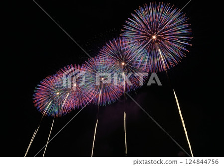 Colorful fireworks reflected on the ocean at dusk 124844756