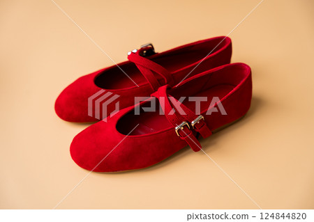 Red suede ballet flats with double straps on neutral background 124844820