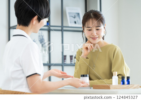 A young woman receiving counseling at a beauty salon A young woman receiving counseling at a beauty salon 124845327