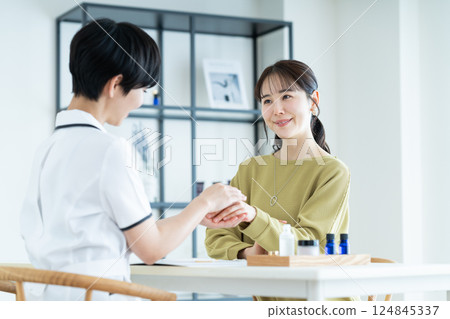 A young woman receiving counseling at a beauty salon A young woman receiving counseling at a beauty salon 124845337