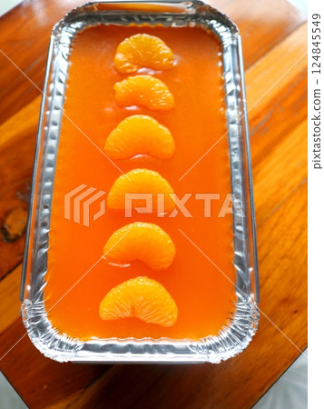 Orange cake rectangle shape on wood. 124845549