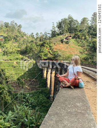 Woman enjoying view of the Nine Arch Bridge, in Demodara, Sri Lanka. Woman enjoying view of the Nine Arch Bridge, in Demodara, Sri Lanka. 124845581