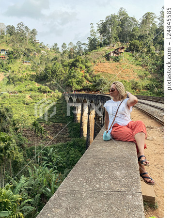Woman enjoying view from the Nine Arch Bridge, in Demodara, Sri Lanka. Woman enjoying view from the Nine Arch Bridge, in Demodara, Sri Lanka. 124845585