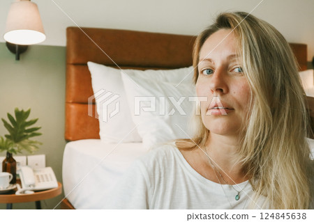 Portrait of beautiful blonde woman in bedroom Portrait of beautiful blonde woman in bedroom 124845638