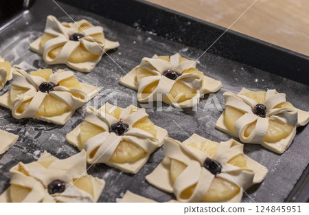 Just baked fruit puff pastry on the baking tray, dusted with powdered sugar 124845951