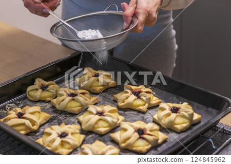Just baked fruit puff pastry on the baking tray, dusted with powdered sugar Just baked fruit puff pastry on the baking tray, dusted with powdered sugar 124845962