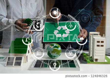 Two colleagues discussing data sustainable development with renewable energy solutions, ecology concept, green business. Two colleagues discussing data sustainable development with renewable energy solutions, ecology concept, green business. 124846326