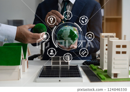 Two colleagues discussing data sustainable development with renewable energy solutions, ecology concept, green business. Two colleagues discussing data sustainable development with renewable energy solutions, ecology concept, green business. 124846330