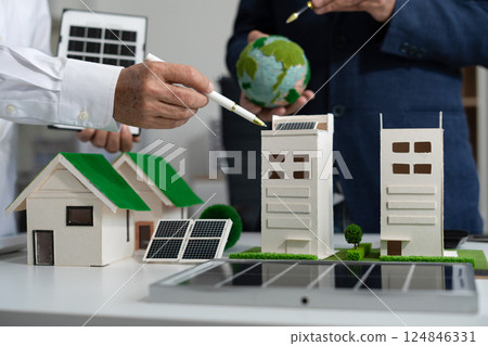 Two colleagues discussing data sustainable development with renewable energy solutions, ecology concept, green business. 124846331