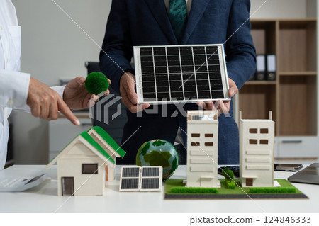 Two colleagues discussing data sustainable development with renewable energy solutions, ecology concept, green business. Two colleagues discussing data sustainable development with renewable energy solutions, ecology concept, green business. 124846333
