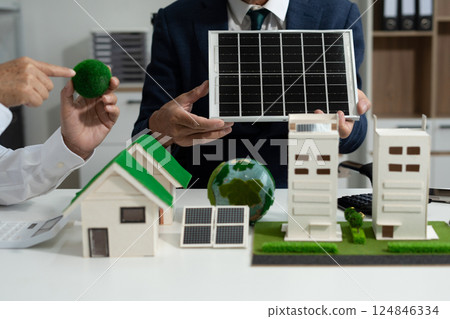 Two colleagues discussing data sustainable development with renewable energy solutions, ecology concept, green business. 124846334