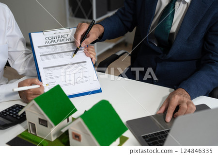 House model with agent asking costumer for contract to buy, get insurance or loan real estate or property. House model with agent asking costumer for contract to buy, get insurance or loan real estate or property. 124846335