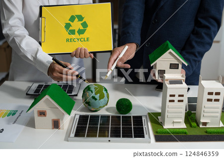 Two colleagues discussing data sustainable development with renewable energy solutions, ecology concept, green business. Two colleagues discussing data sustainable development with renewable energy solutions, ecology concept, green business. 124846359