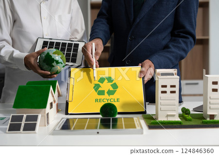 Two colleagues discussing data sustainable development with renewable energy solutions, ecology concept, green business. Two colleagues discussing data sustainable development with renewable energy solutions, ecology concept, green business. 124846360
