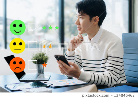 Male businessman holding a digital smartphone with checkboxes rating smiley faces excellent for Satisfaction Survey, Happy Client Customer Experience concept. 124846462