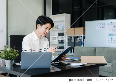 Happy man, entrepreneur, small business owner working online. Happy man, entrepreneur, small business owner working online. 124846476