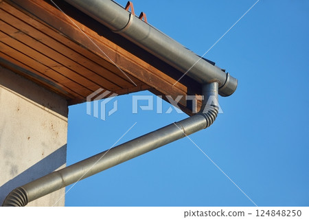 Gutter pipe eaves trough of a house 124848250