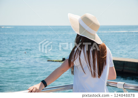 Young woman relaxing summer day on a yacht with stunning ocean view. Happy summer days, travel and vacation concept 124848878
