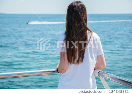 Peaceful ocean view with girl on yacht enjoying summer travel. Happy summer days, travel and vacation concept 124848881