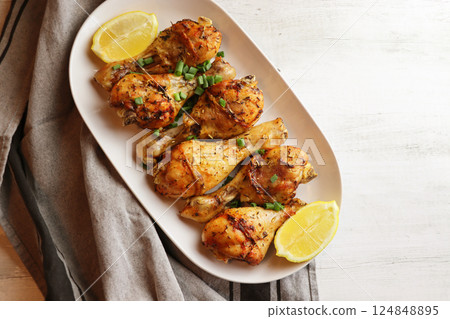 Grilled chicken. Spicy grilled chicken legs, drumsticks on the white plate. Top view. 124848895