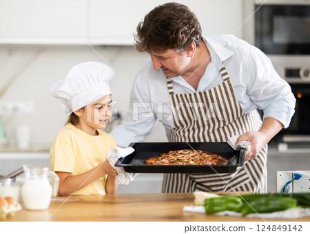 Father and daughter prepared pizza in kitchen Father and daughter prepared pizza in kitchen 124849142