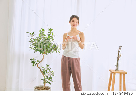 Woman drinking water in a glass Woman drinking water in a glass 124849489