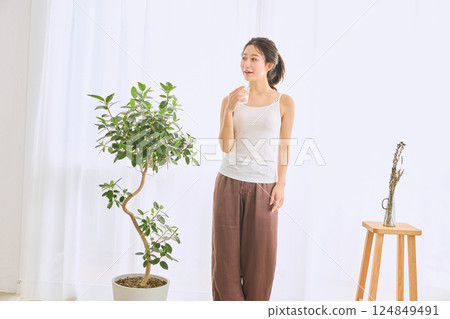 Woman drinking water in a glass Woman drinking water in a glass 124849491