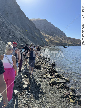 travelers walking along the mountain on the beach travelers walking along the mountain on the beach 124849499