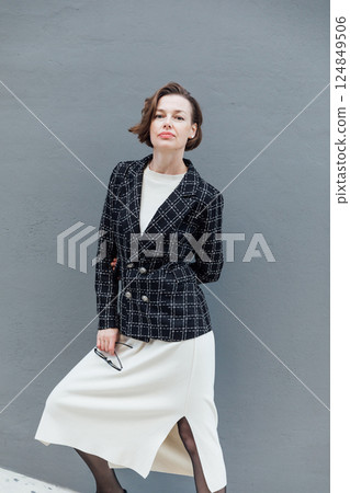 Fashionable Woman in Jacket and Skirt on Gray Background 124849506