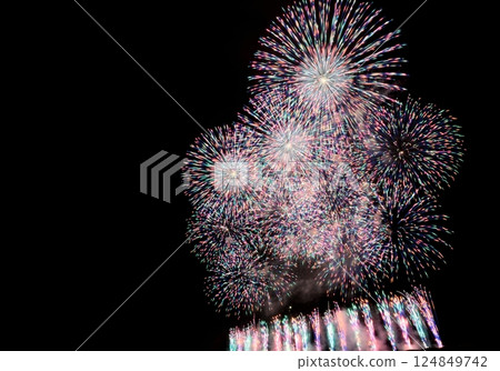 A series of colorful fireworks bursting into the midnight sky 124849742