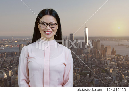 Portrait of asian business woman in glasses. Eiffel Tower with cityscape background. Portrait of asian business woman in glasses. Eiffel Tower with cityscape background. 124850423