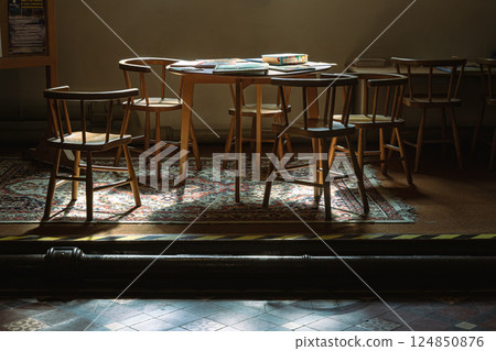 Sunbeam rays filtered through in to the Wooden tables and chairs. Sunbeam rays filtered through in to the Wooden tables and chairs. 124850876